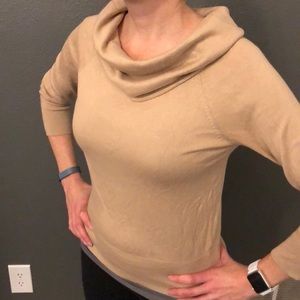 Cowl neck form fitting stretchy knit sweater.